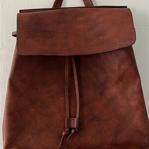 Sleek Brown Leather Backpack with Flap and Drawstring